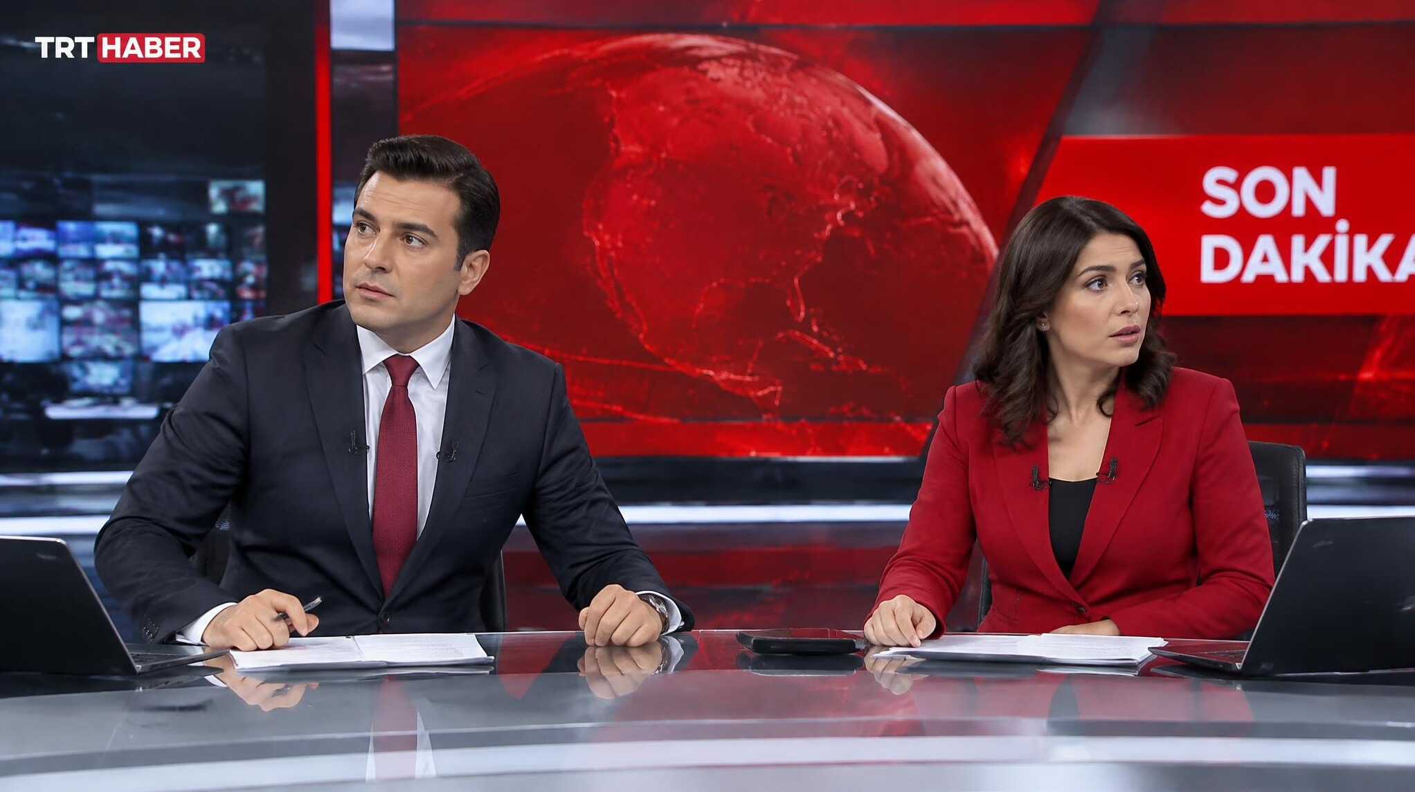 Breaking news anchor team reacting to a live studio crisis in Turkey