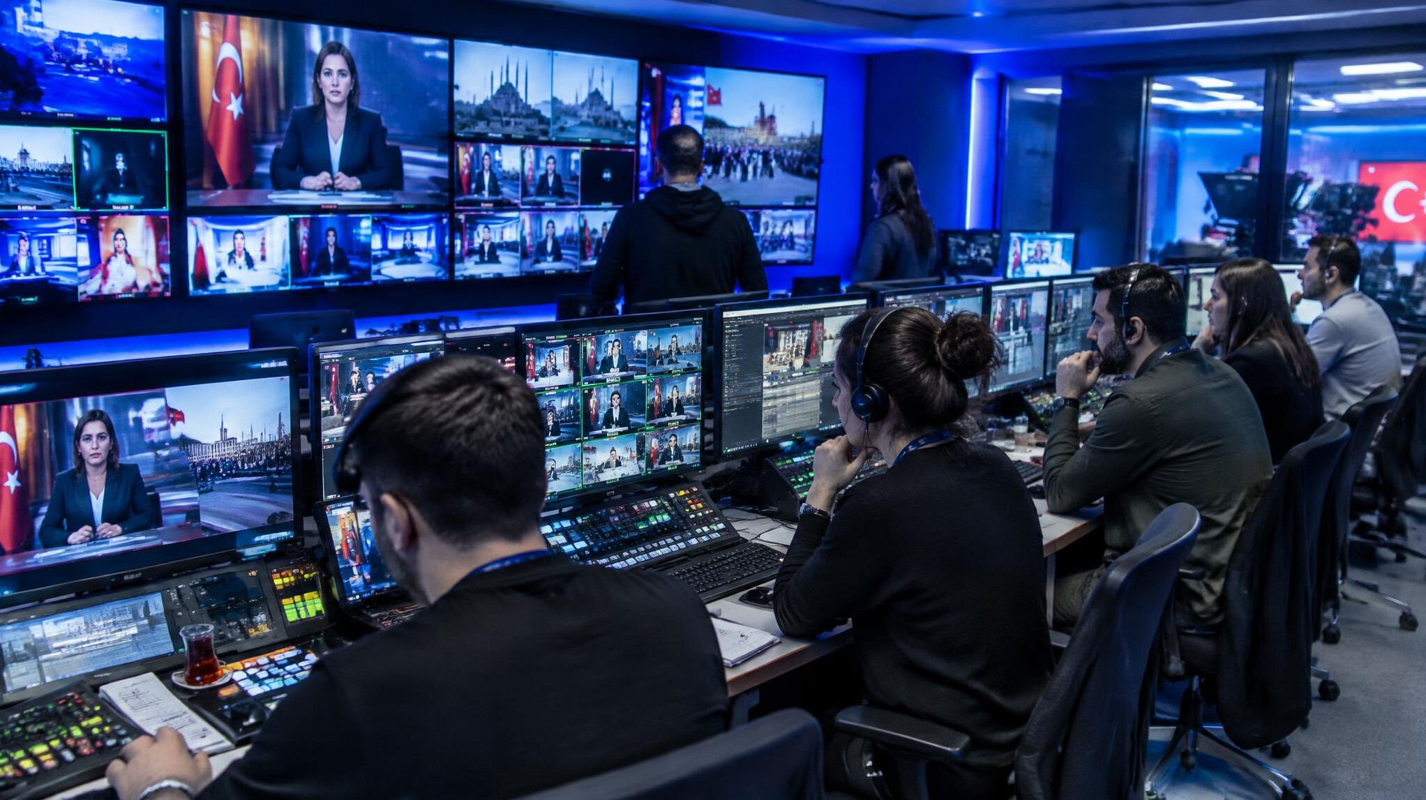 Turkish broadcast control room with editors monitoring live feeds on multiple screens